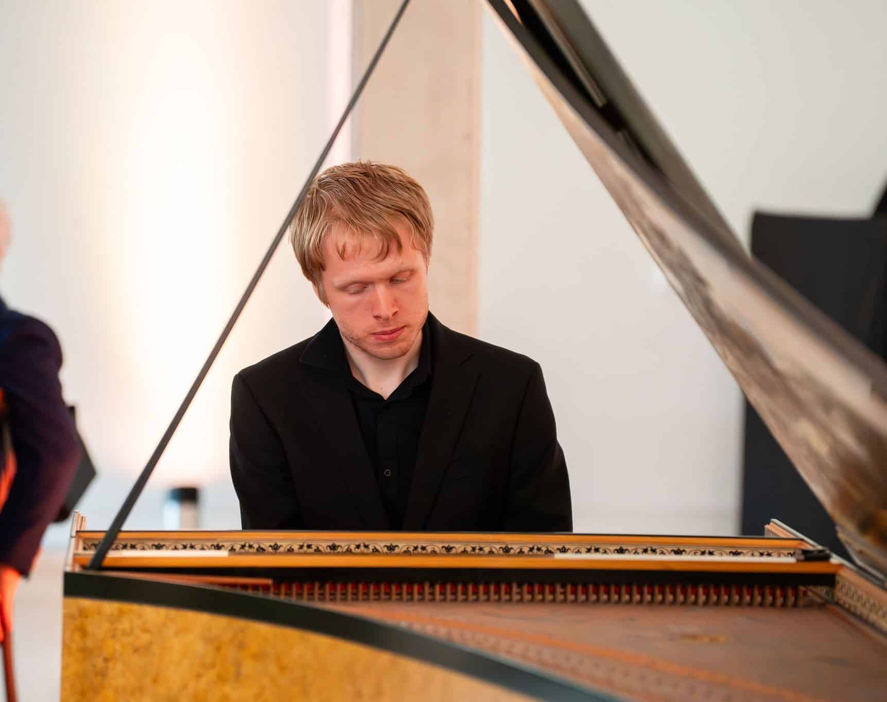 Photo of Alexander playing the piano