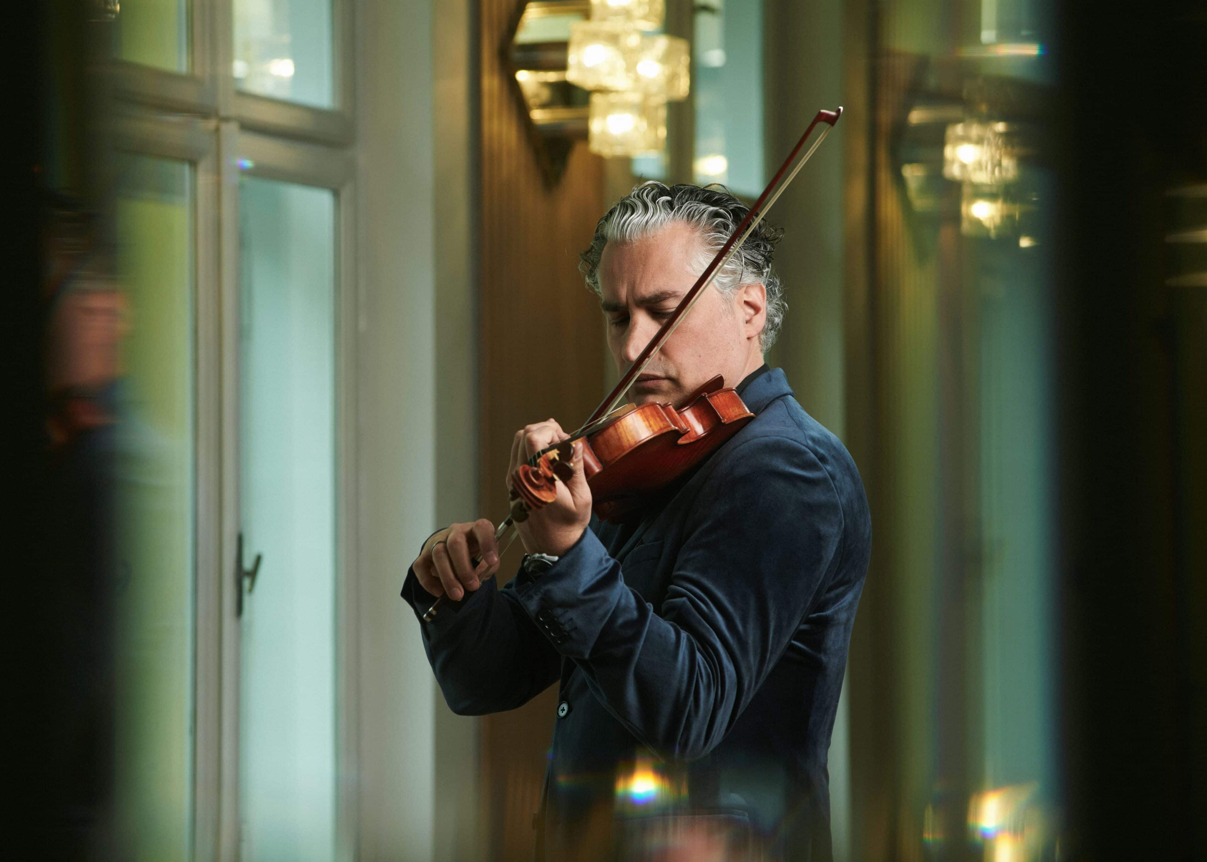Photo of Remy playing the violin